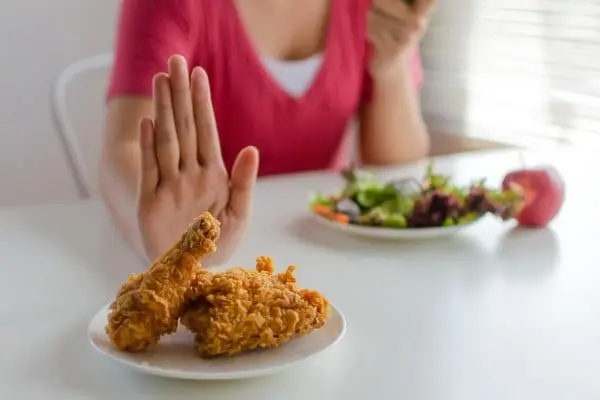 woman saying no to unhealthy food
