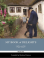 little boy looking up at old man, in garden, next to house