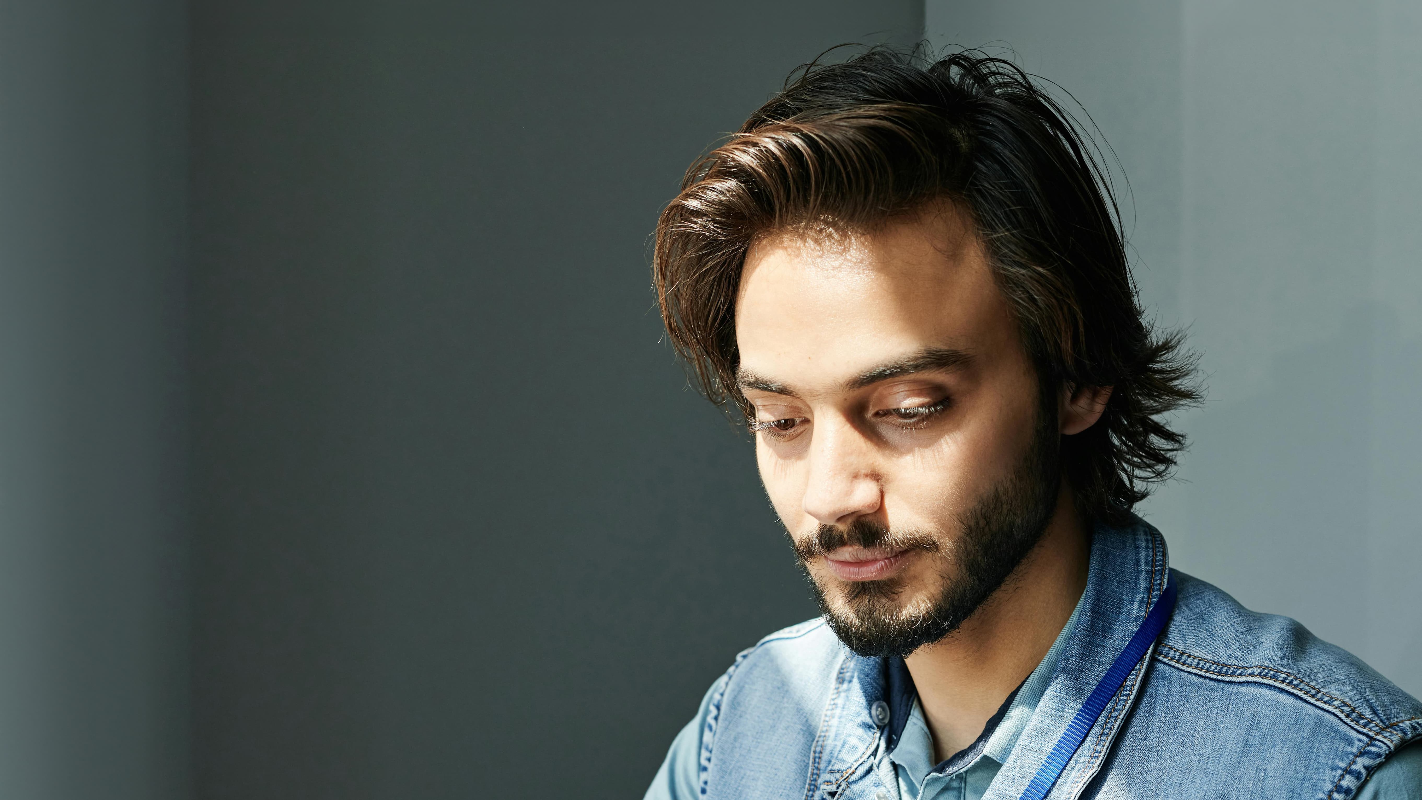 man inside a room looking down