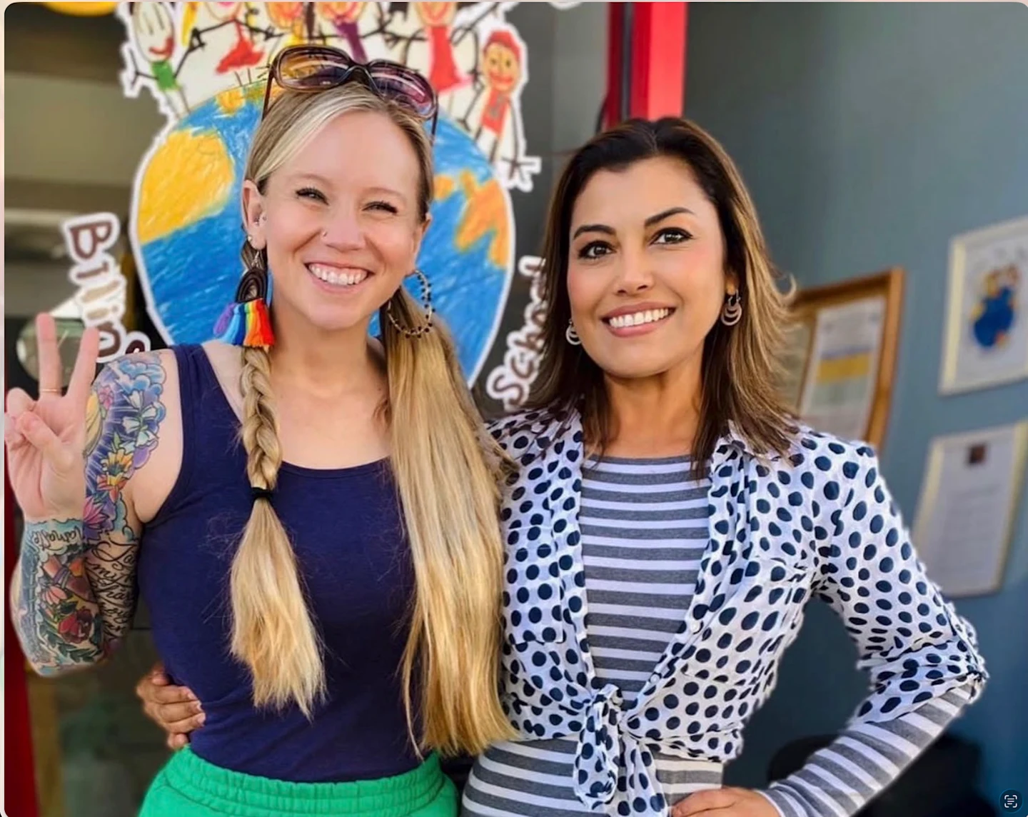 Two of Casa del Niño’s owners smiling outside the school