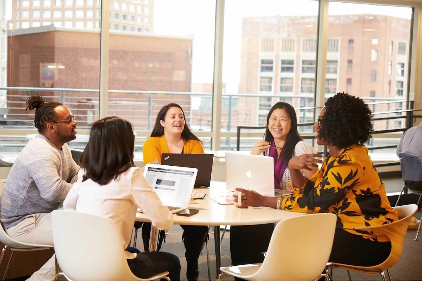 Several Houghton Mifflin Harcourt employees sitting around a table.