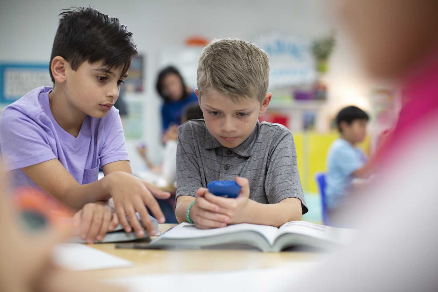 A couple of kids in a classroom environment.