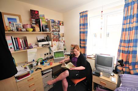 Student reading in an En suite room at Eildon Annexe student residences Student reading in an En suite room at Eildon Annexe student residences
