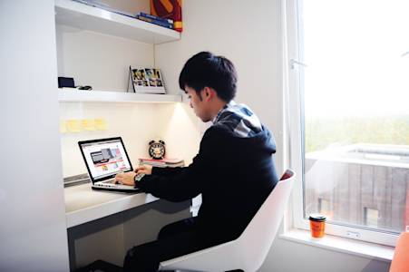 Student studying in a bedroom in Scape East in London Student studying in a bedroom in Scape East in London