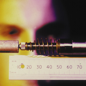 INTO student measuring a piece of mechanical equipment with close-up of ruler INTO student measuring a piece of mechanical equipment with close-up of ruler