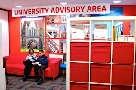 University advisory area in centre with staff helping international student University advisory area in centre with staff helping international student