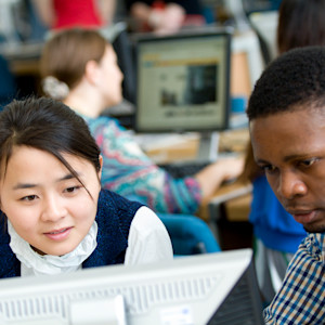Two international students in computer lab. Two international students in computer lab.