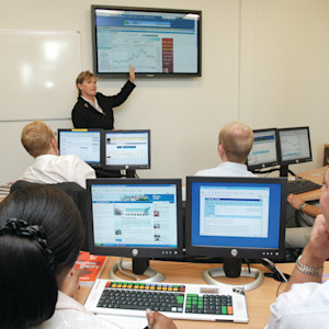 Teacher explains financial graph to students in University of Exeter classroom Teacher explains financial graph to students in University of Exeter classroom