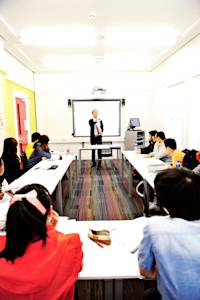 International students in classroom with teacher and white board International students in classroom with teacher and white board