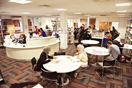 International students working in Learning Resource Centre with help desk International students working in Learning Resource Centre with help desk