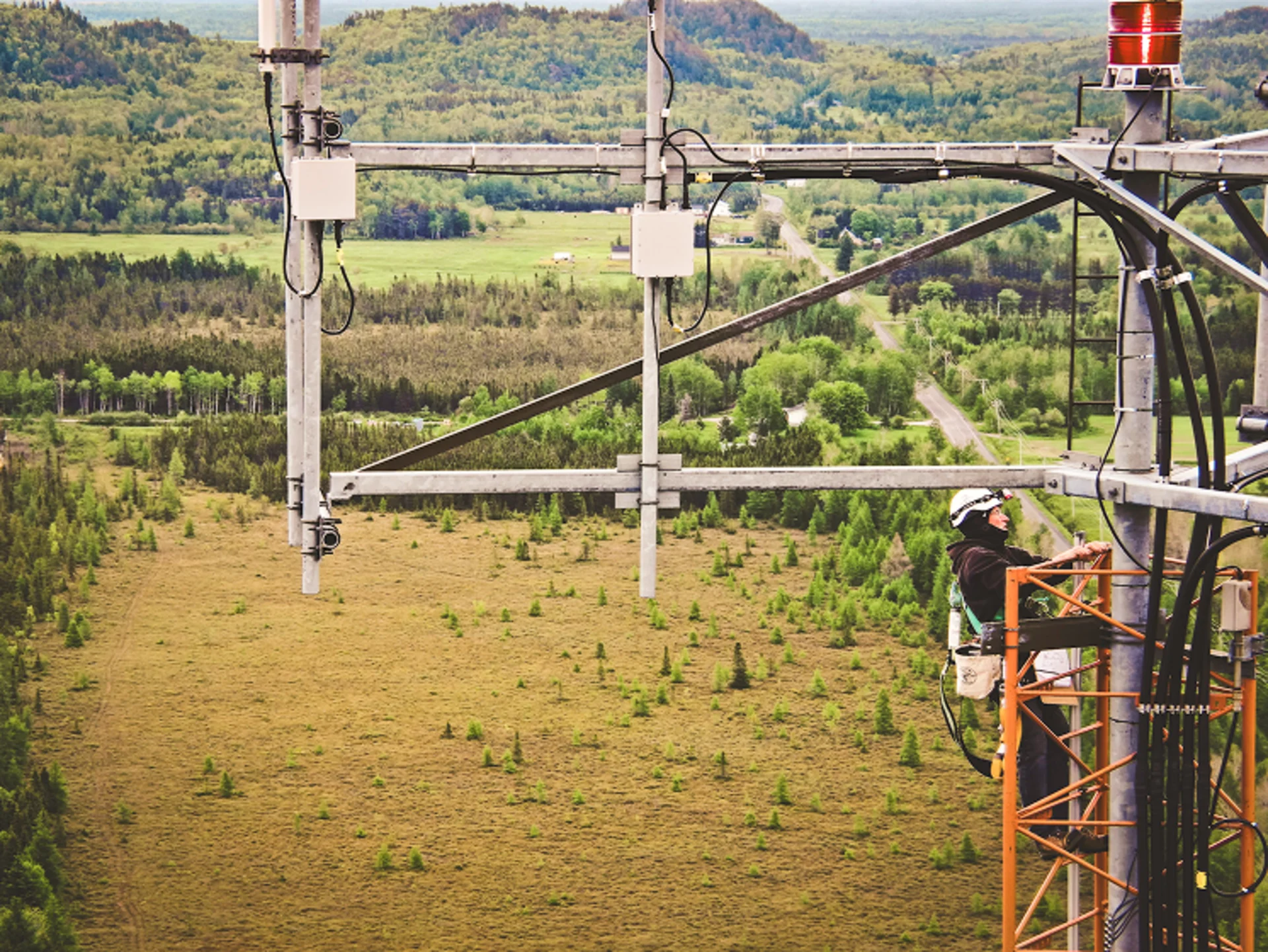 Cell tower with nature background, drone photo
