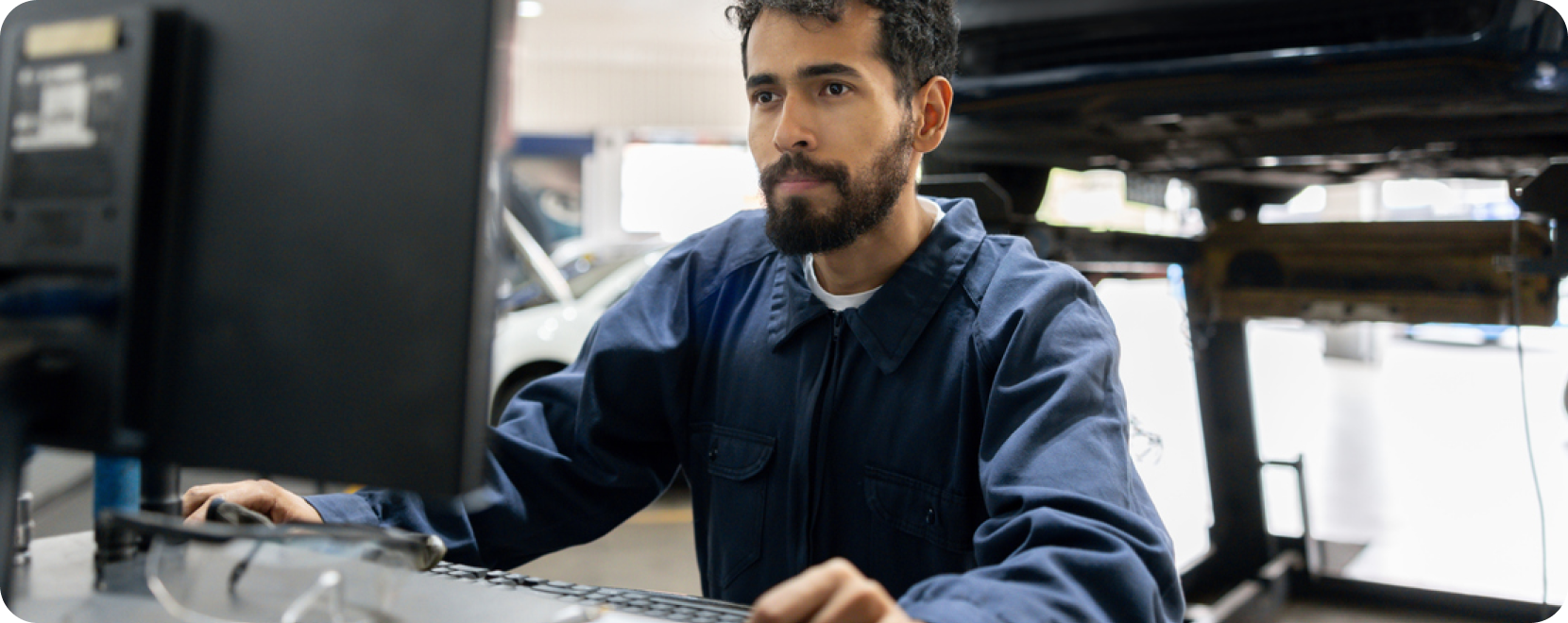 man with beard on desktop computer