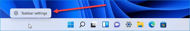 Red arrow pointing to the "Taskbar settings" option opened from right-clicking the Windows 11 taskbar.