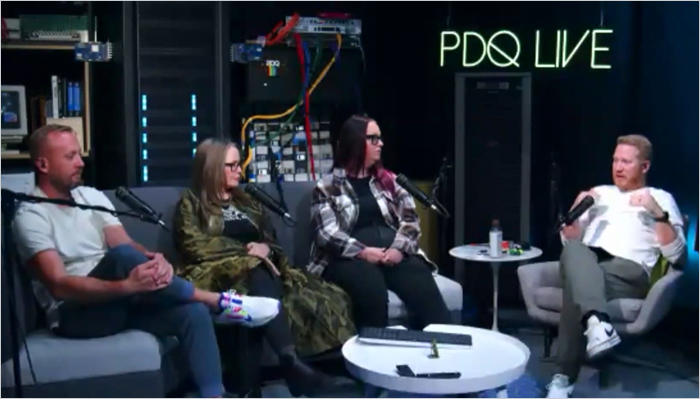 PDQ webinar panel discusses shadow AI risks in IT environments, with four speakers seated in a studio surrounded by networking equipment and microphones.