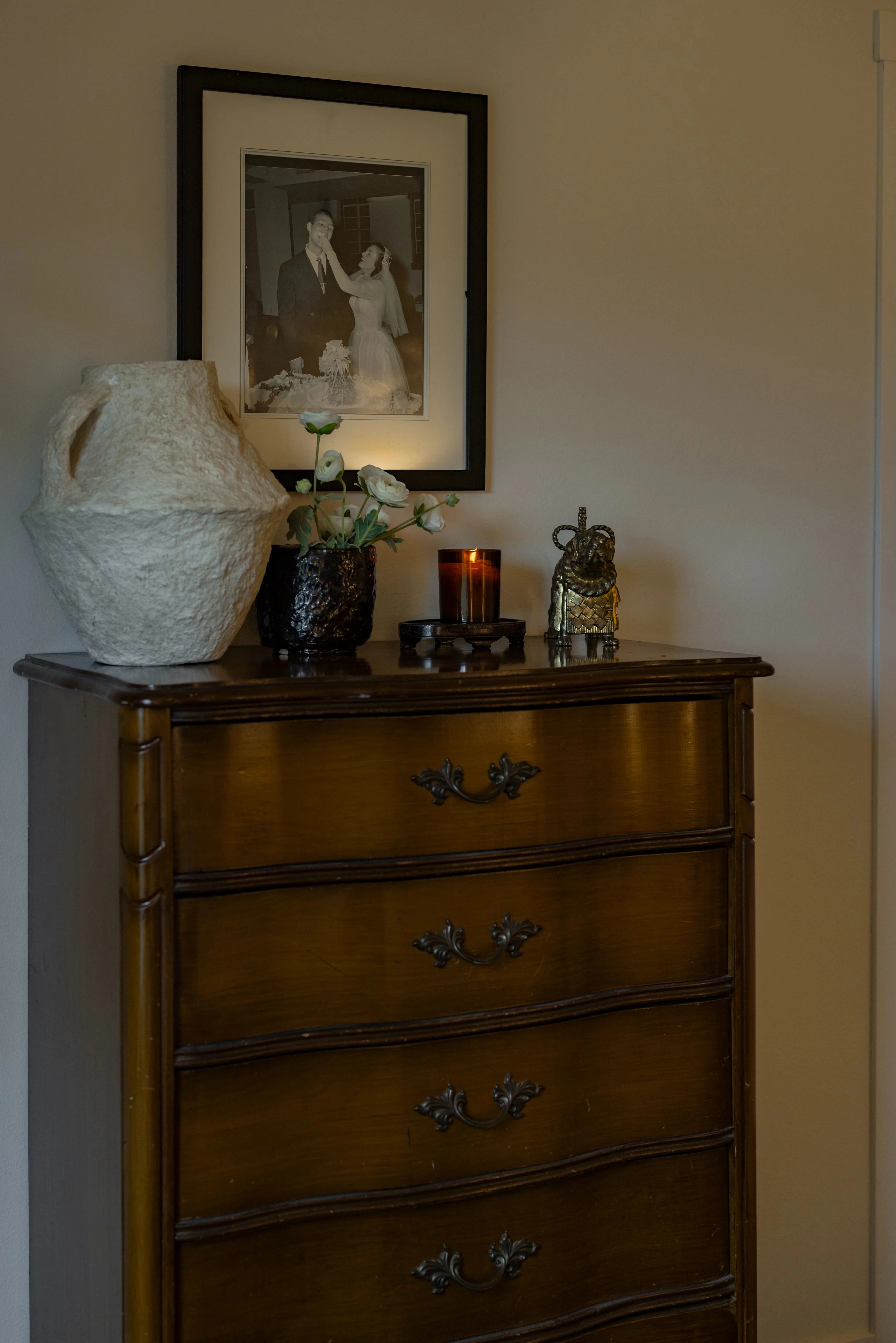 A black and white photo of Koven’s grandparents hanging above an antique dresser.