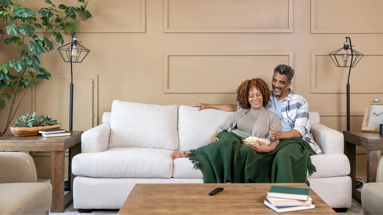 A couple sits inside their new construction home and reviews their home insurance policy.