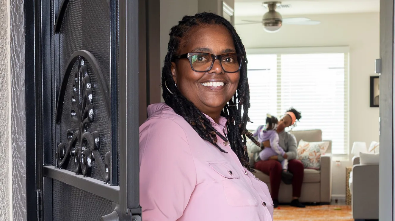 Theresa Williams standing at her front door