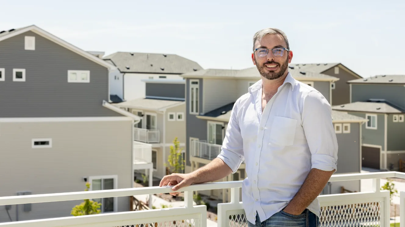  Justin Jones standing on the rooftop porch of his Oakwood Home