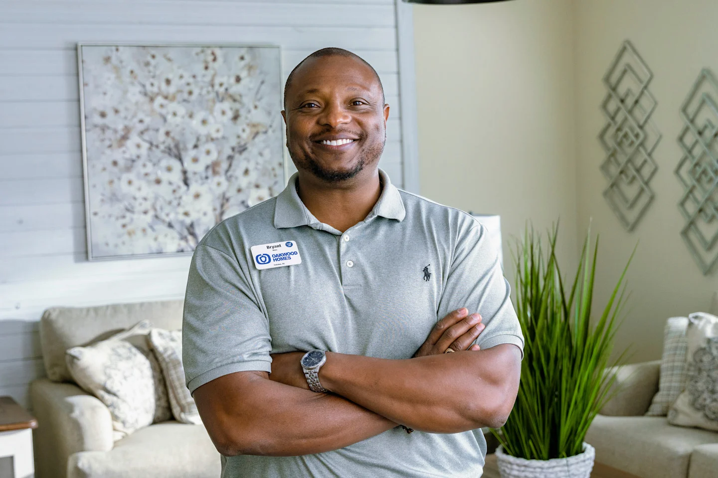 Black man smiles and stands inside of a Clayton home.