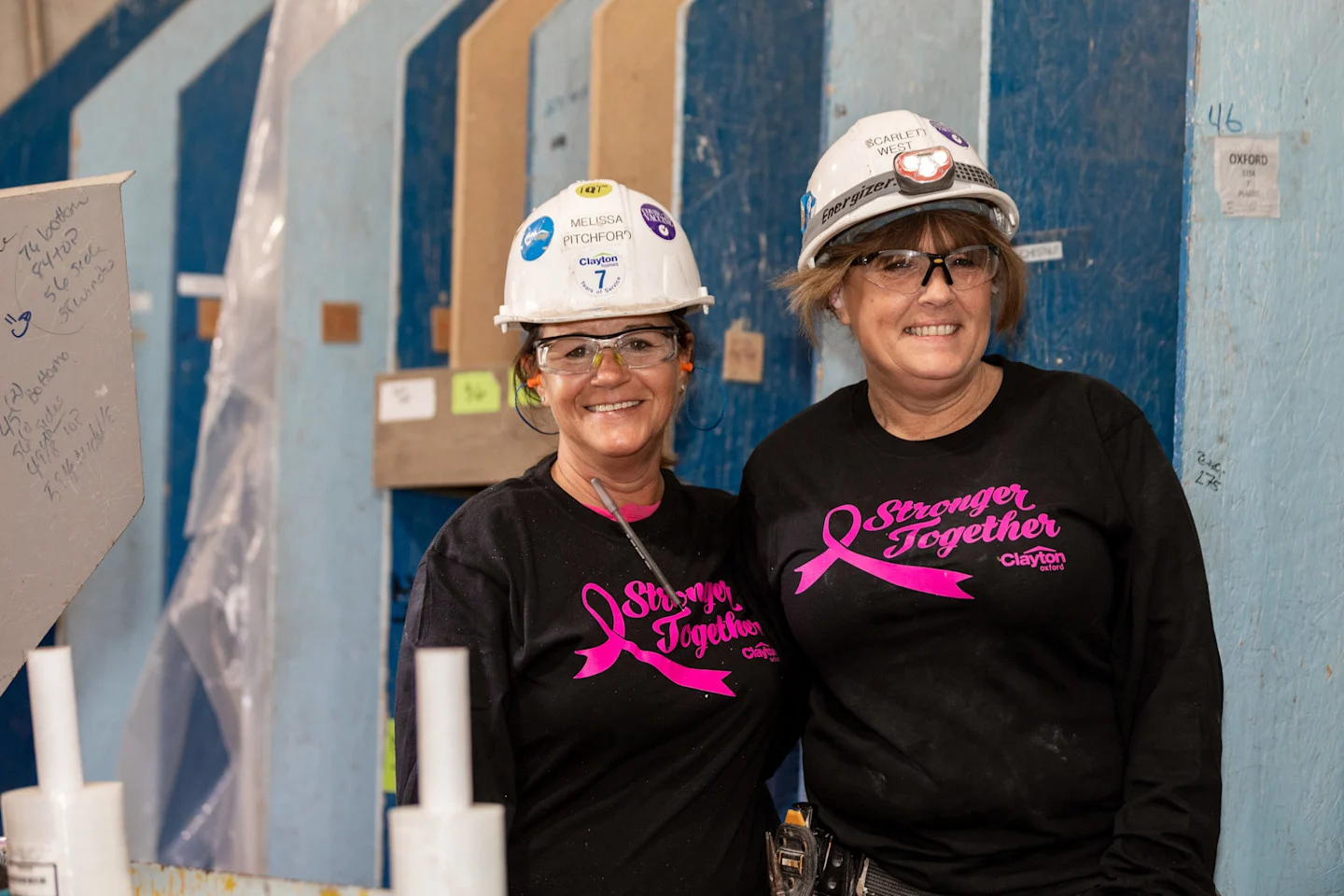 Two Clayton Oxford team members wearing 'Stronger Together' shirts to raise money for Duke Cancer Institute