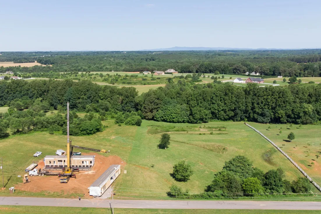 Home exterior of construction site for a modern manufactured home land preparation and site set up.