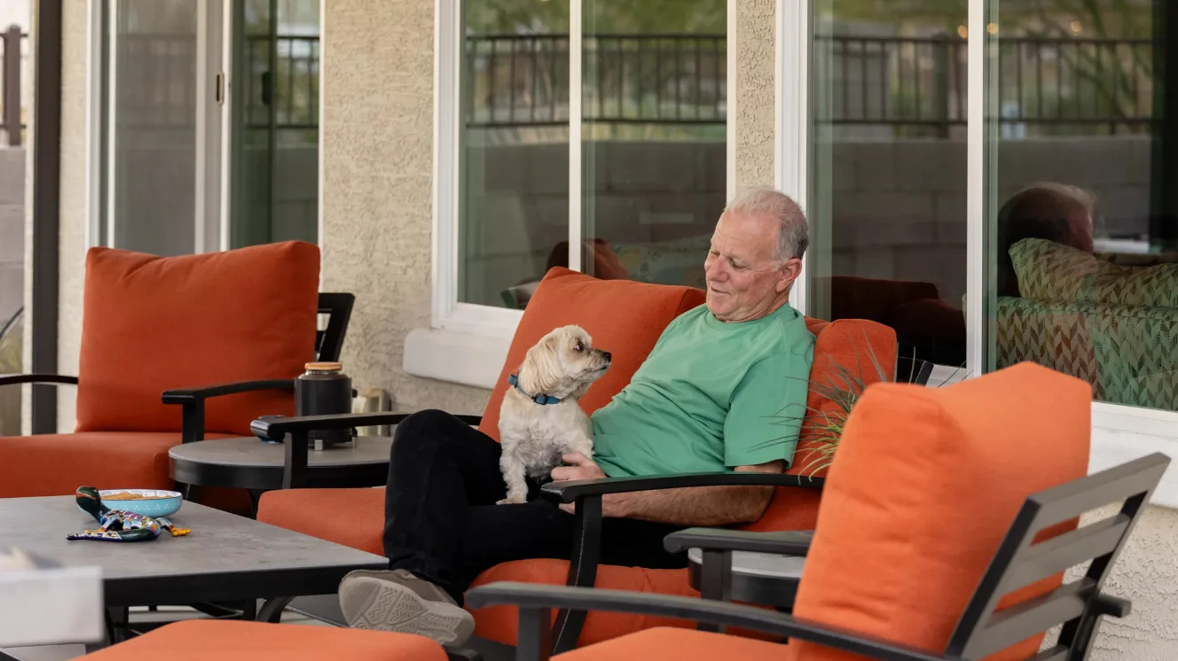 Don and his dog Munkee sitting on the patio together