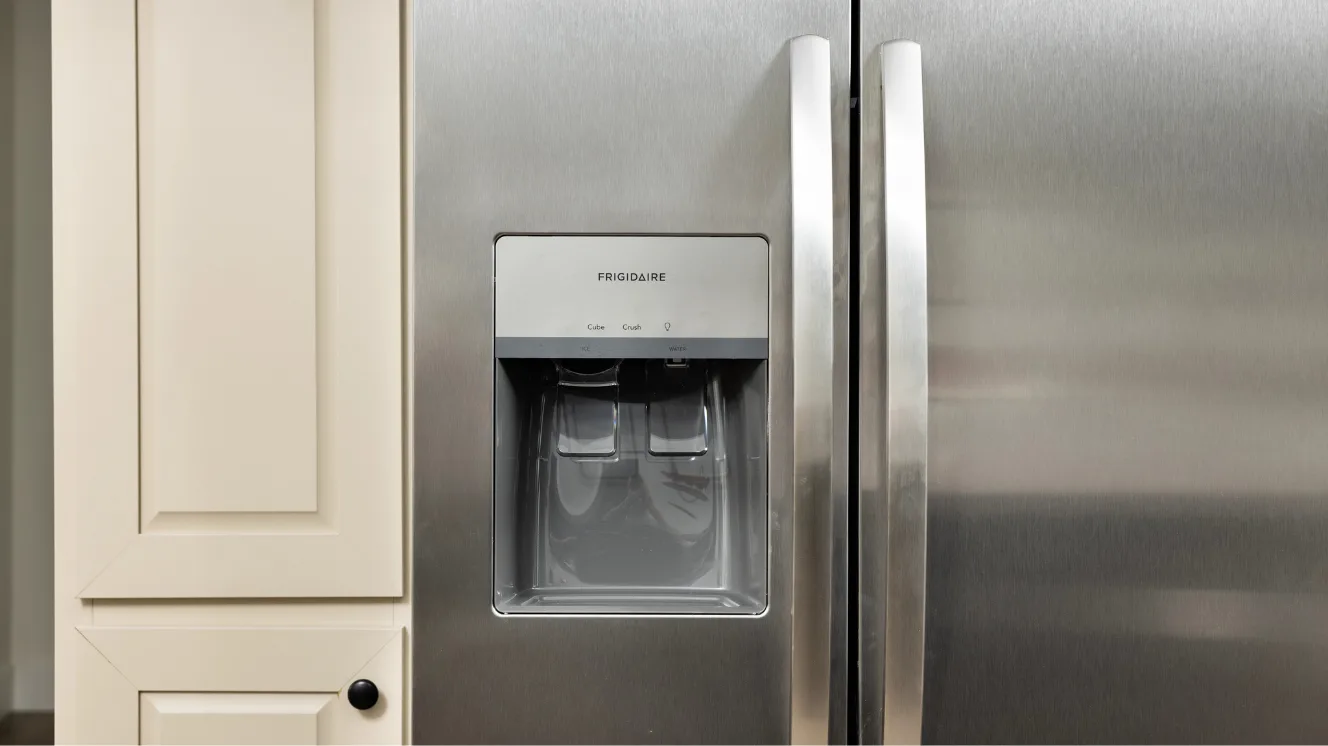 A close-up of a stainless steel, side-by-side Frigidaire fridge.