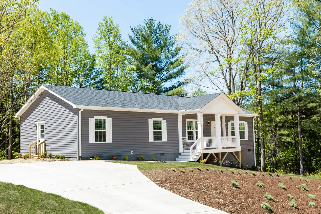 Home exterior of a modern manufactured CrossMod home on land.