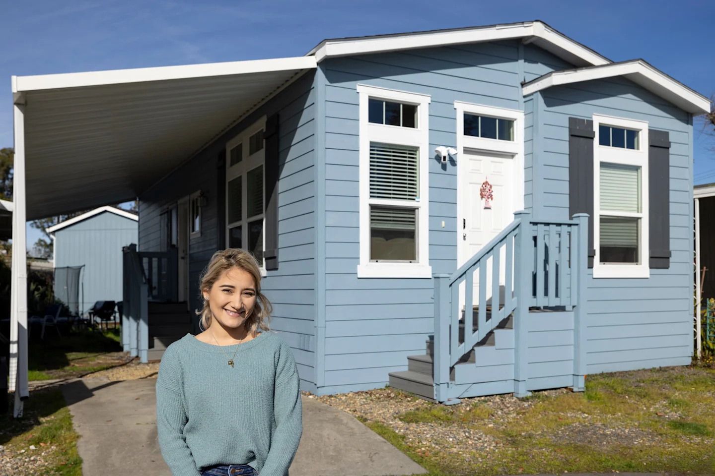 Maria Cibrian standing in front of her manufactured home