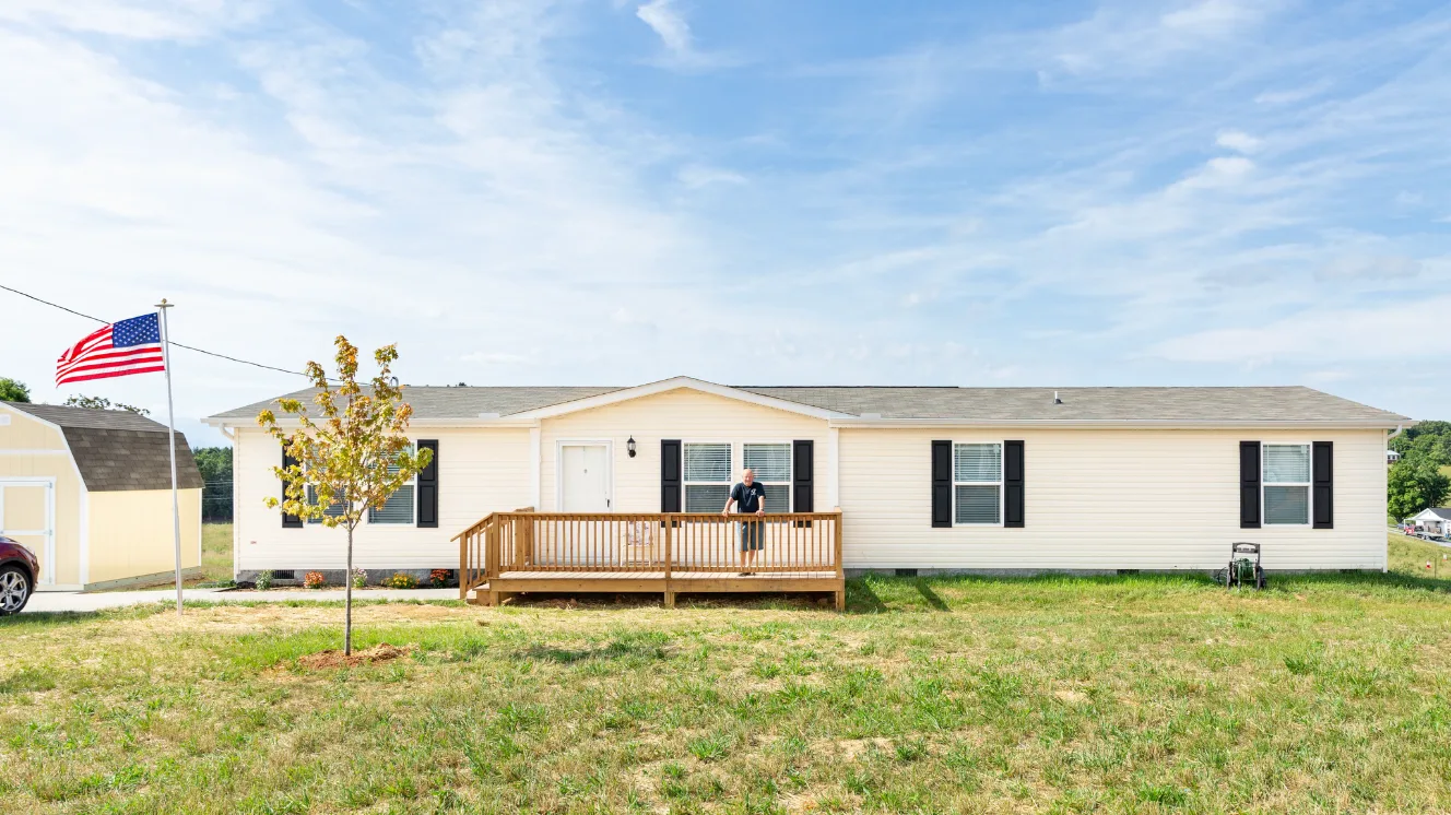 Manufactured home with yellow vinyl siding placed in East Tennessee.