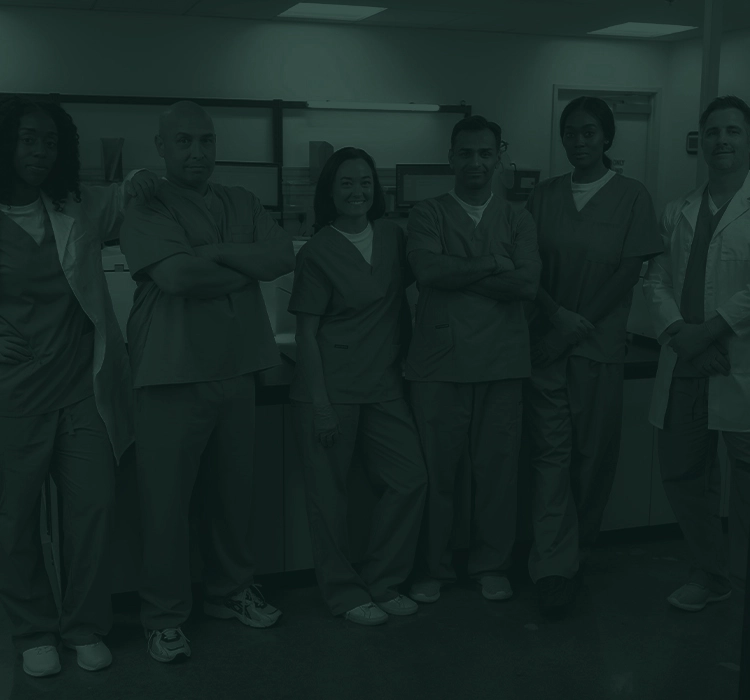 Group of lab technicians standing together in a lab.
