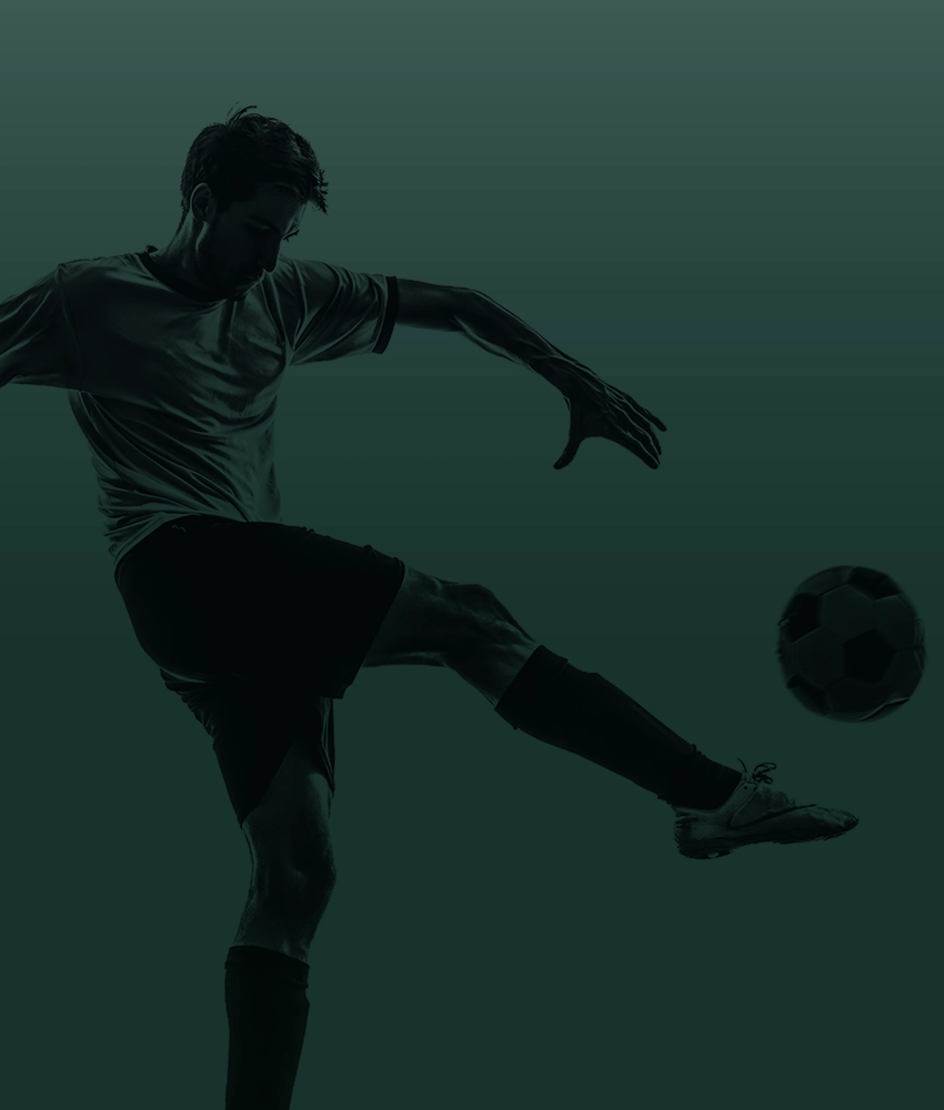 Man kicking a soccer ball.