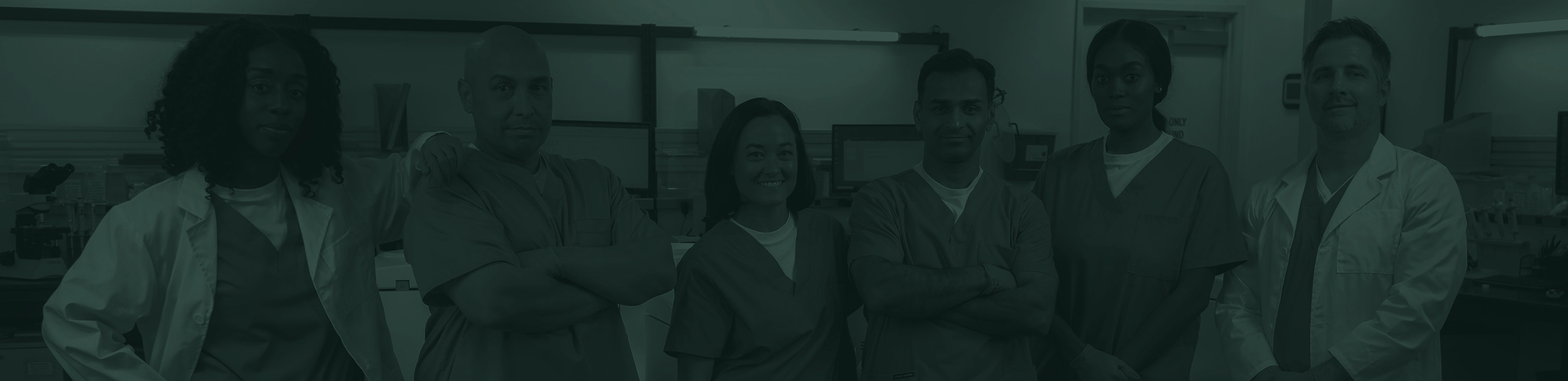 Group of lab technicians standing together in a lab.