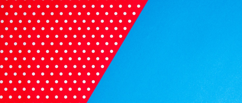 Red and white dotted material against blue background.