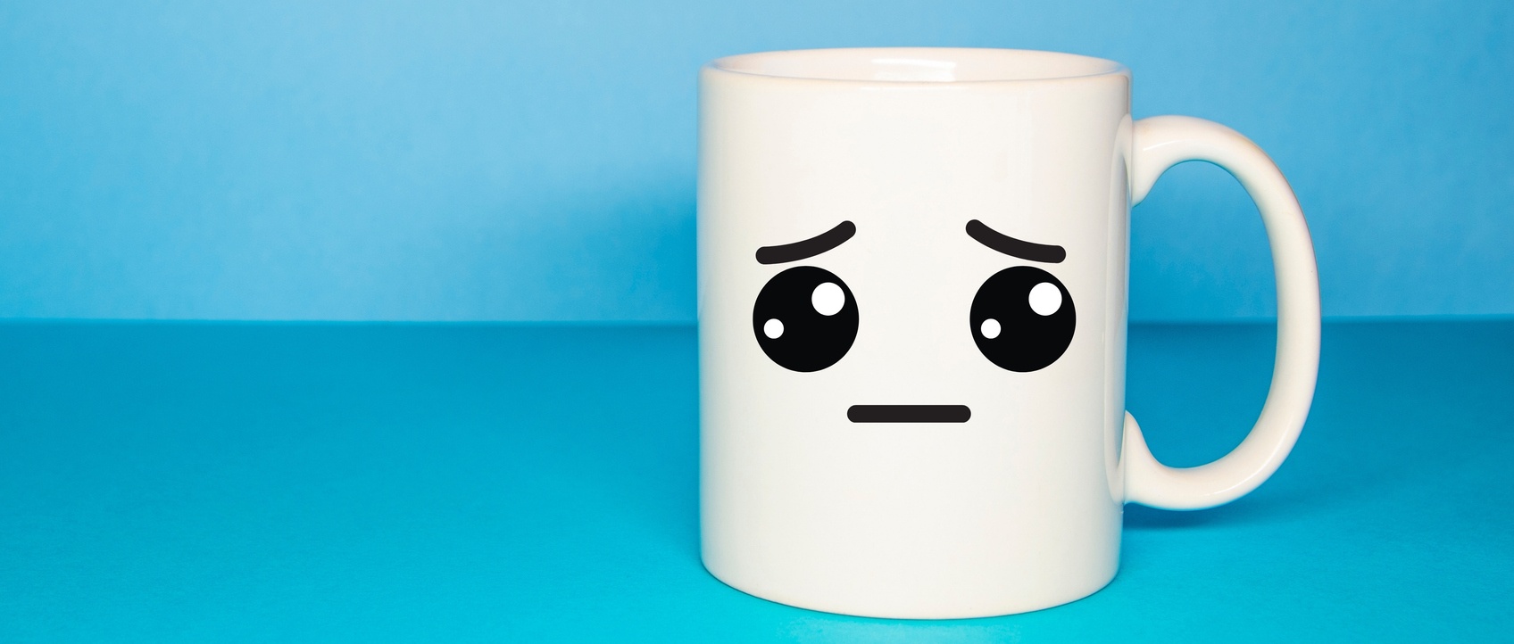 Blue cup with a sad smiley