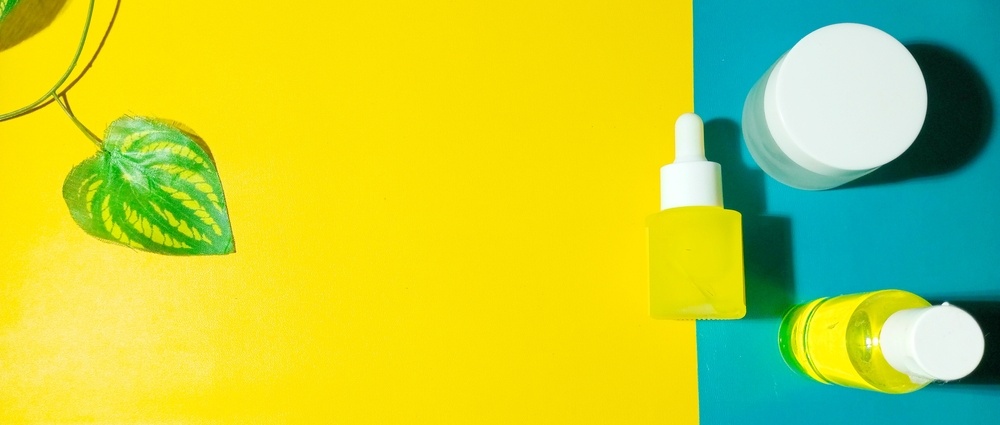 Facial care items with 3 different packaging placed on a 2-color carpet, flat lay concept, lifestyle, and abstract background.