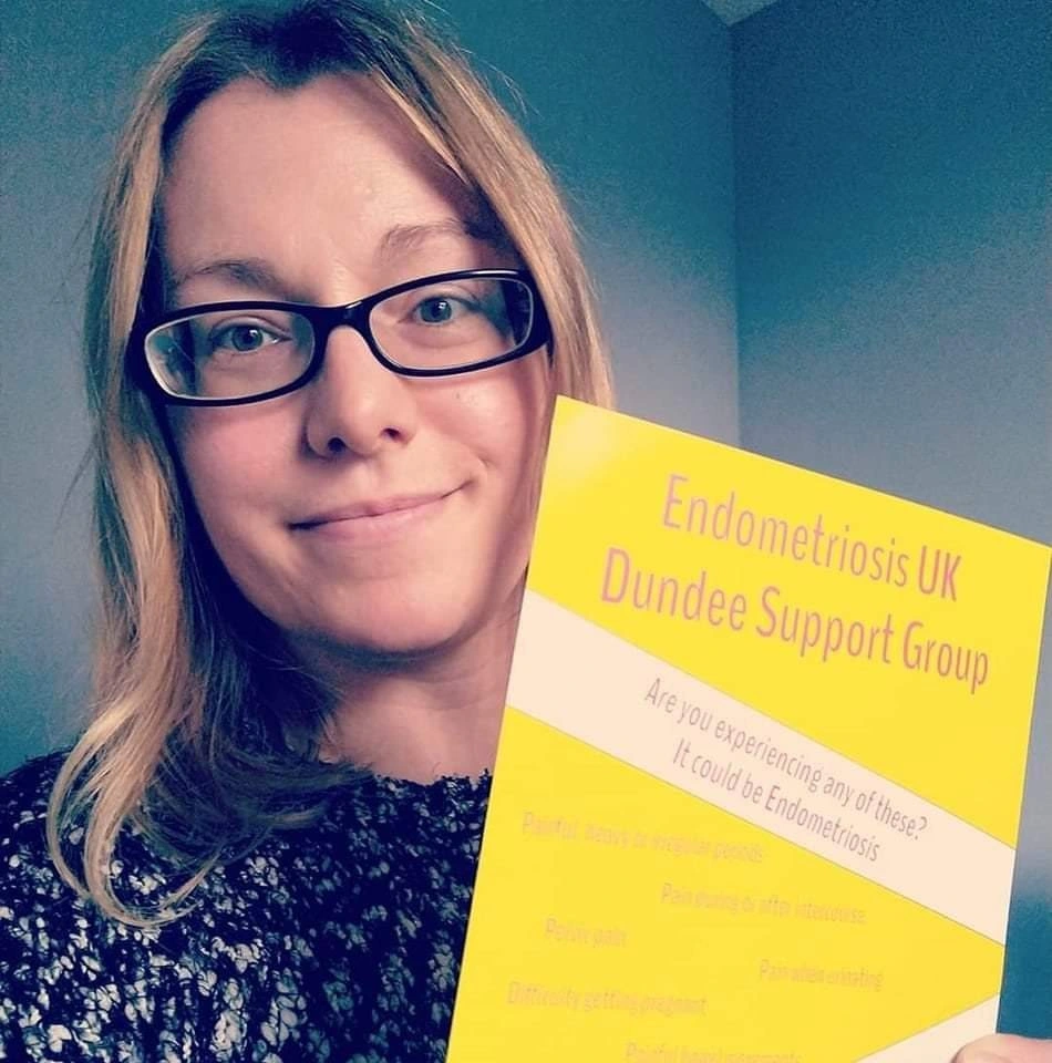 Photo of Vicky holding up a "Endometriosis UK Dundee Support Group" poster