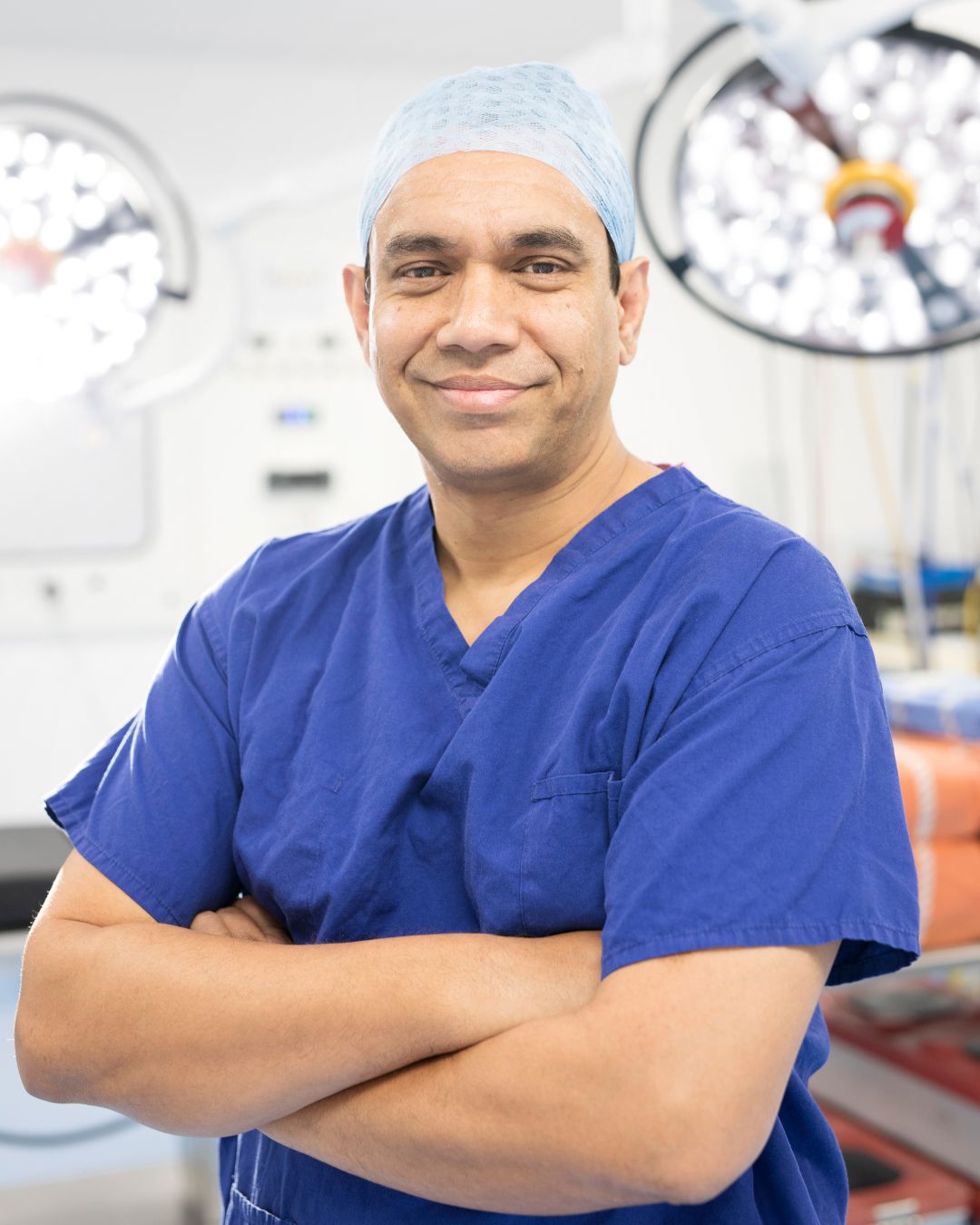 Photo of Dr Nurul Ahad wearing blue medical scrubs