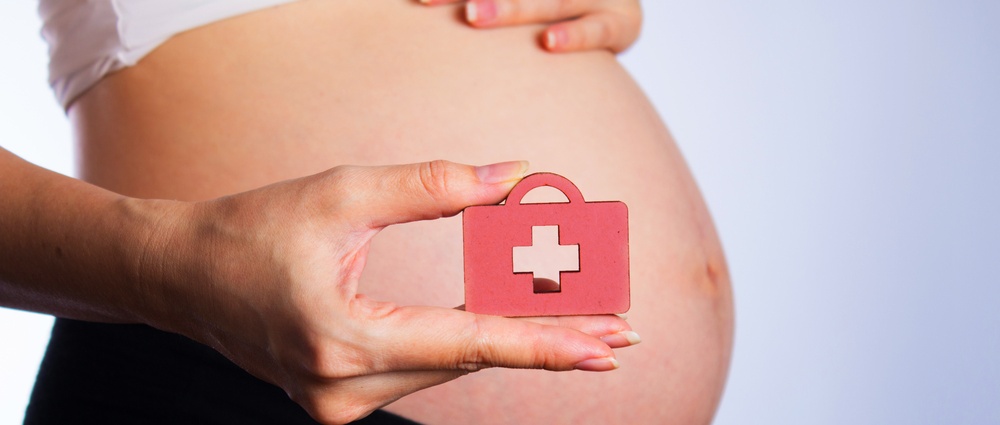 Pregnant woman in white underwear. Young woman expecting a baby.