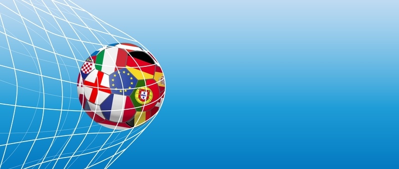 Football caught in net with various flags printed all around its surface against blue background.