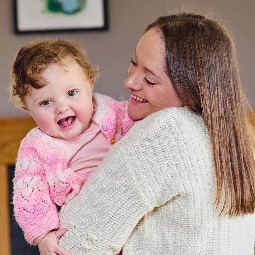 Keisha's baby peeping over her shoulder