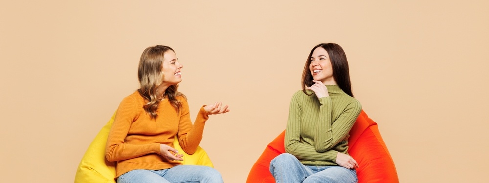 Photo of two women on beanbags talking
