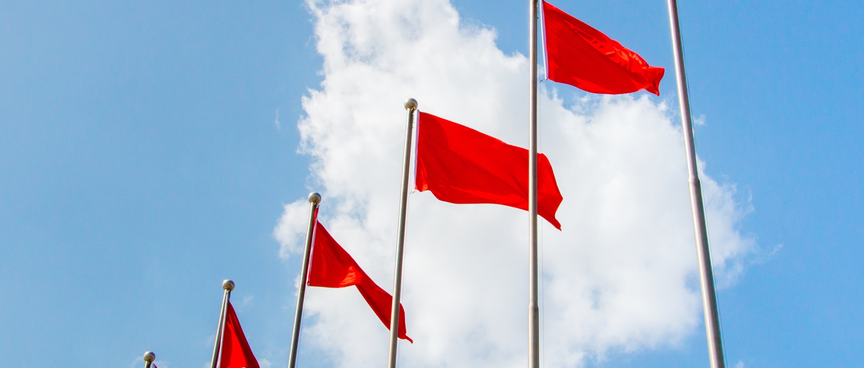 Red flags against blue sky.