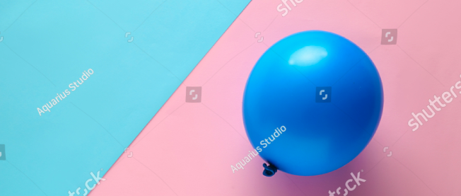 Dark blue balloon on split bright pink and blue background.