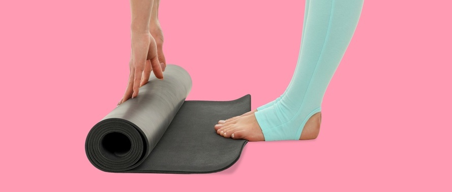 Yoga mat is rolled up by a person in a bright area