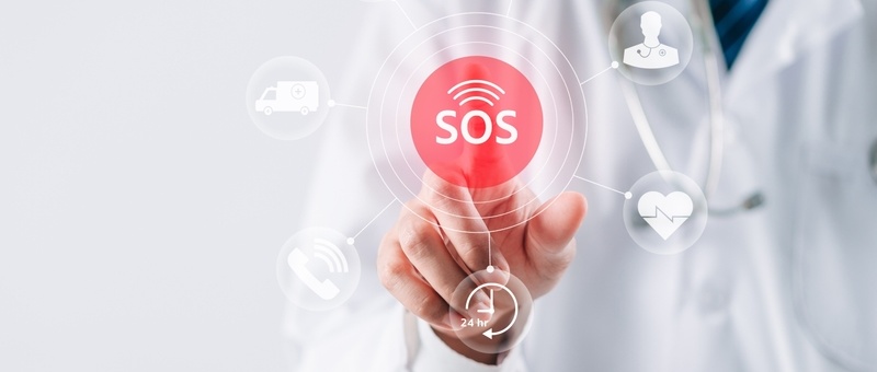 A medical professional touching a digital SOS button surrounded by healthcare icons including ambulance and heartbeat symbols.