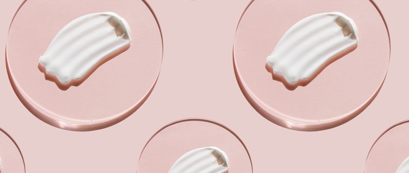 White cream texture on a pink background. Pattern.