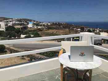 A laptop sitting on a table overlooking a beautiful horizon in Athens, Greece