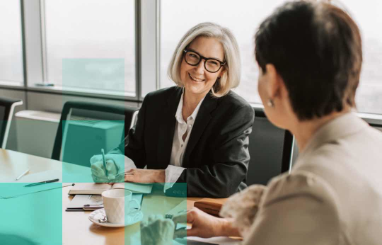 Two colleagues talking in meeting, decorative image