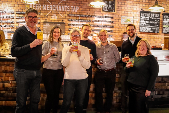 Cynergy Business Finance and Cave Direct team pictured standing together holding drinks 